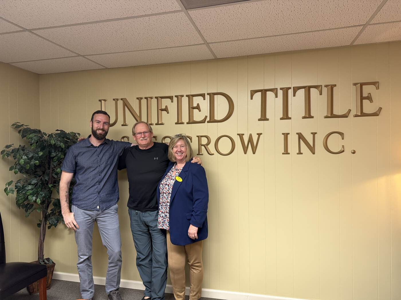 Sam Timlick with a buyer and real estate agent at a Tri-Cities closing